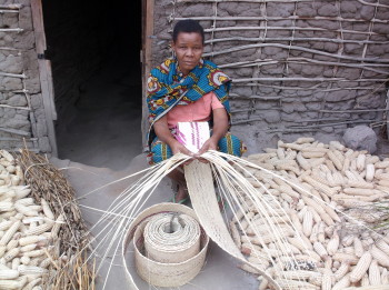 Basila loves the handiwork of this artisan; a customer uses a solar lamp at night for her work.