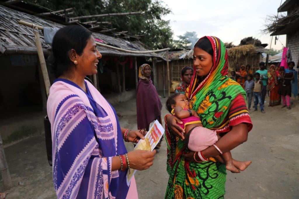 An Accredited Social Health Activist (ASHA) interacts with a young mother during a home visit. ASHAs are trained and supported by Pathfinder International to address special needs of young mothers, including family planning and healthy birth spacing, to protect maternal health. Home visits by ASHAs are often the only family planning services young mothers receive.