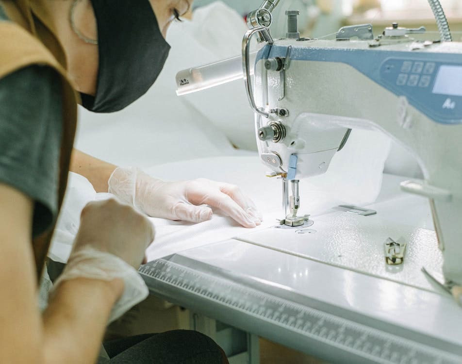 Woman using a sewing machine in a factory