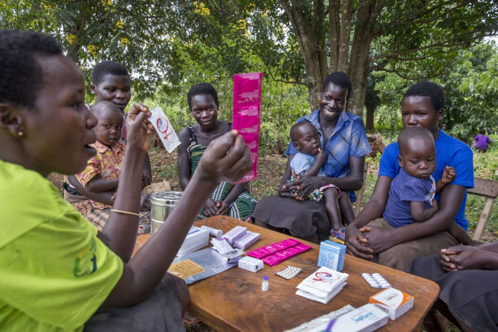 Women from the Young Mothers Group meeting and getting family planning information from a community health worker. The program is supported by Reproductive Health Uganda, with the goal to empower the women in the group, and provide them with family planning information.