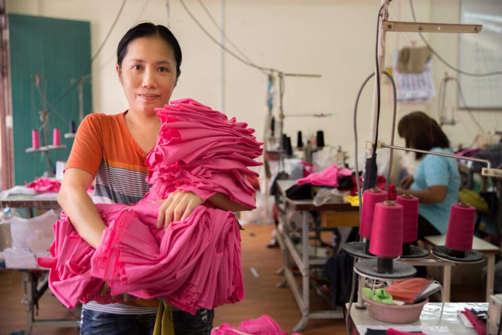 Khamhla Tongburan works at a small garment factory on the outskirts of Bangkok with 15 other workers. Together, they form the Solidarity Group, a collective of former factory garment workers who now run their own enterprise, providing fair wages and working hours in a safe environment. The Solidarity Group has its own brand: "Dignity Returns." Members have joined other home-based garment worker groups under HomeNet Thailand's Informal Worker Association to establish a garment cooperative.